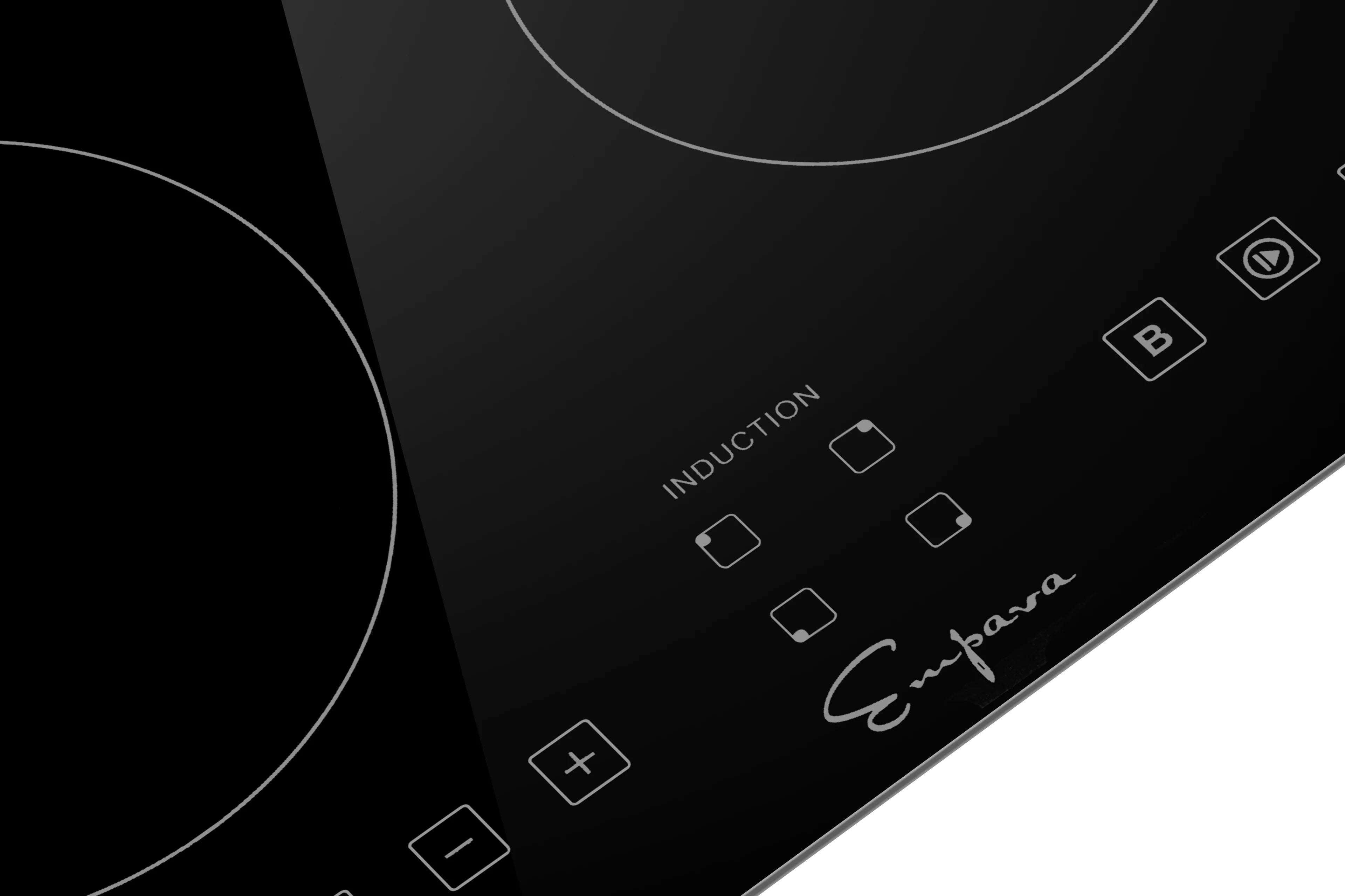 Close-up of black induction cooktop touch controls and Induction zone icons
