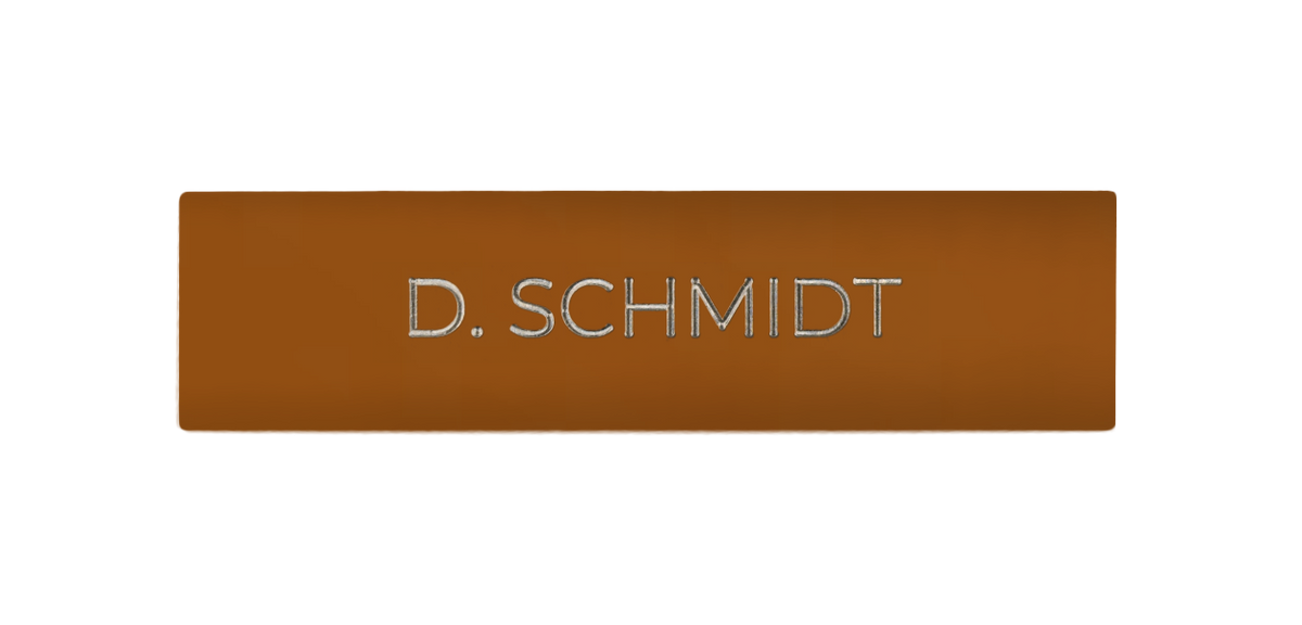 Orange-brown engraved door nameplate with white text lettering