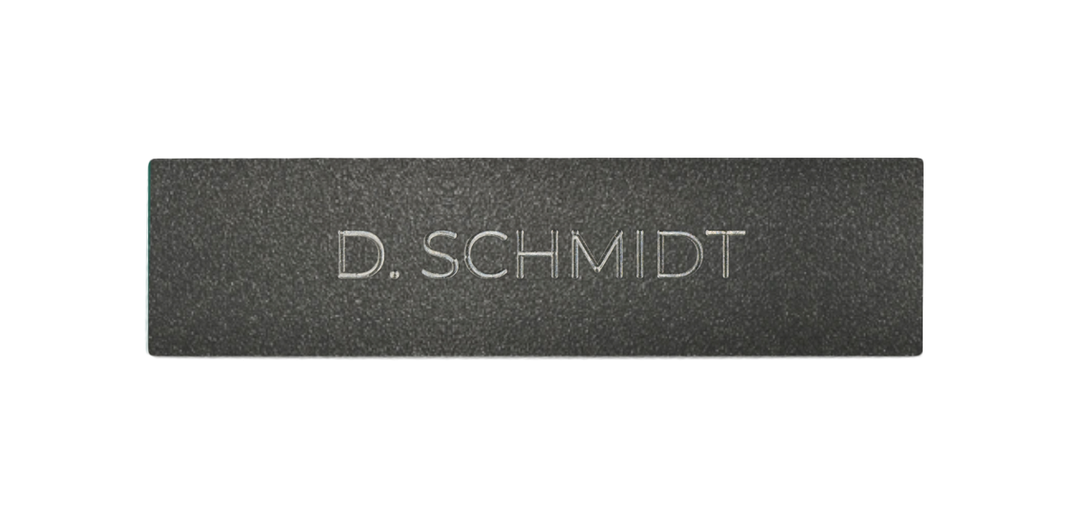 Stainless steel nameplate with engraved D. SCHMIDT lettering