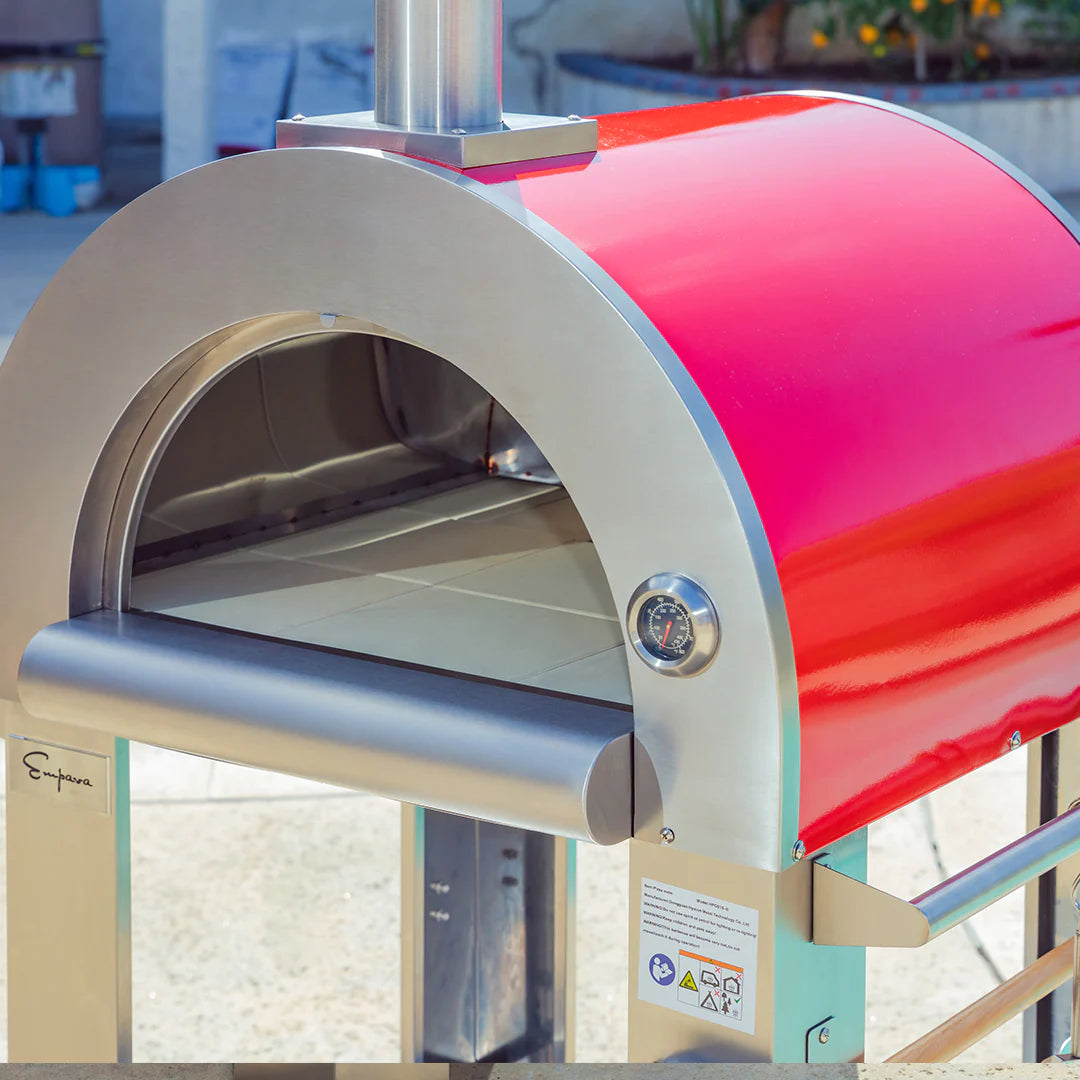 Red and stainless pizza oven dome with control dial and arched opening