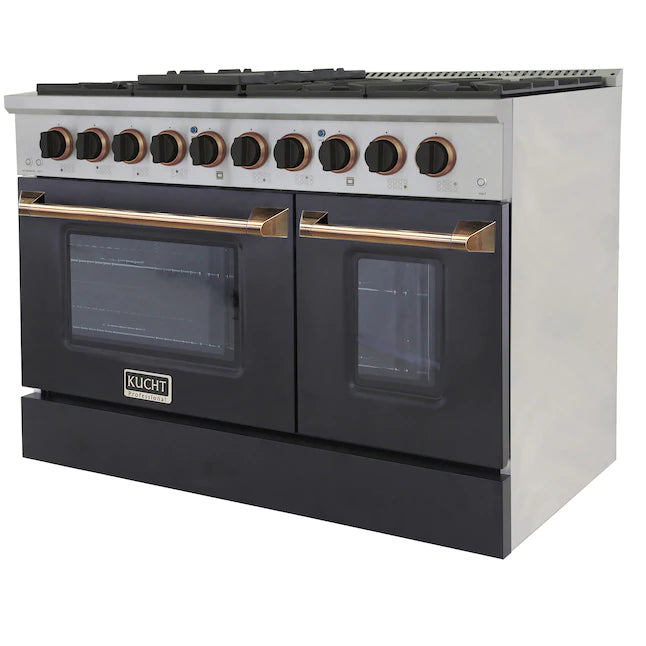 Dual oven range front with two black glass doors and gold handle rails
