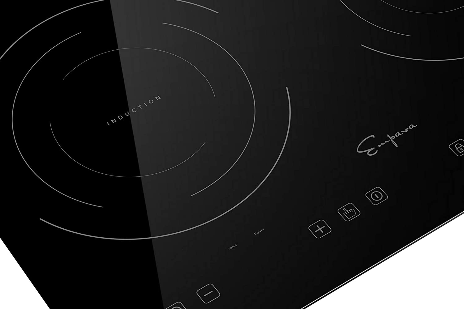 Black induction cooktop close-up of burner zone graphics and nearby touch control icons