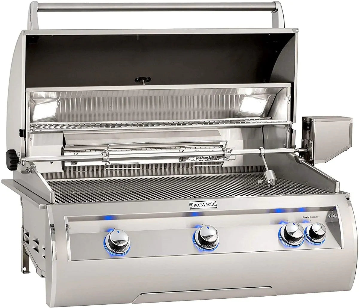 Built-in gas grill with open hood, stainless burners, and front control knobs