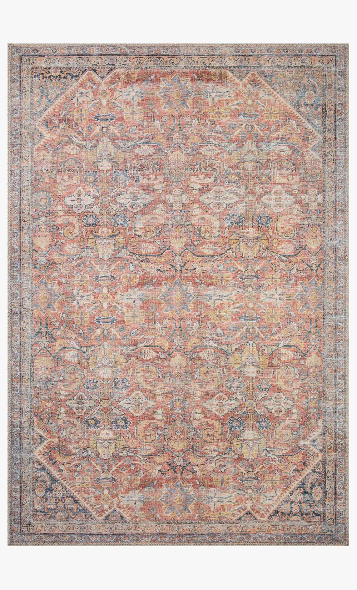 Traditional power-loomed rug with ornate rust, denim, and blue medallion pattern.