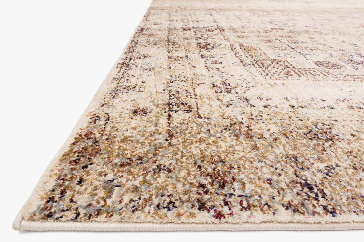 Ivory transitional power-loomed rug angled view with distressed multicolor abstract border