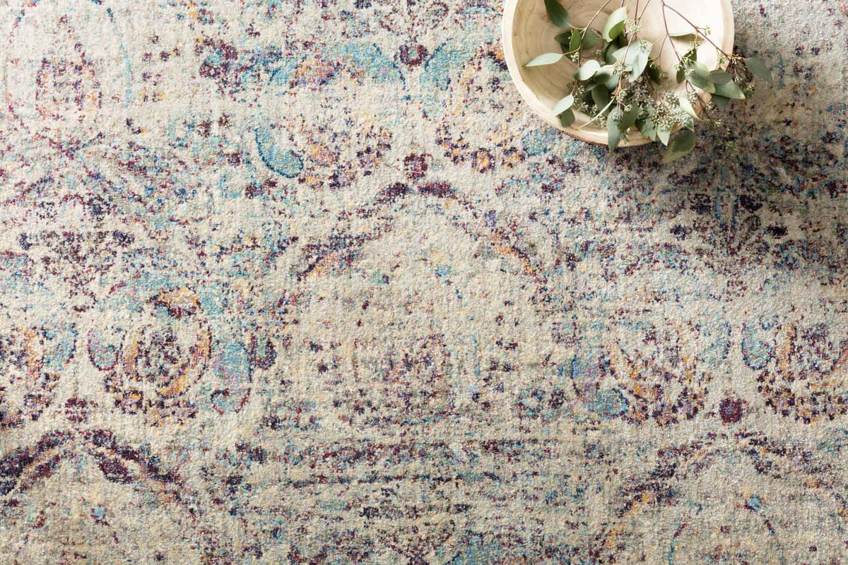 Silver, plum and blue abstract rug texture close-up with ornate speckled motifs