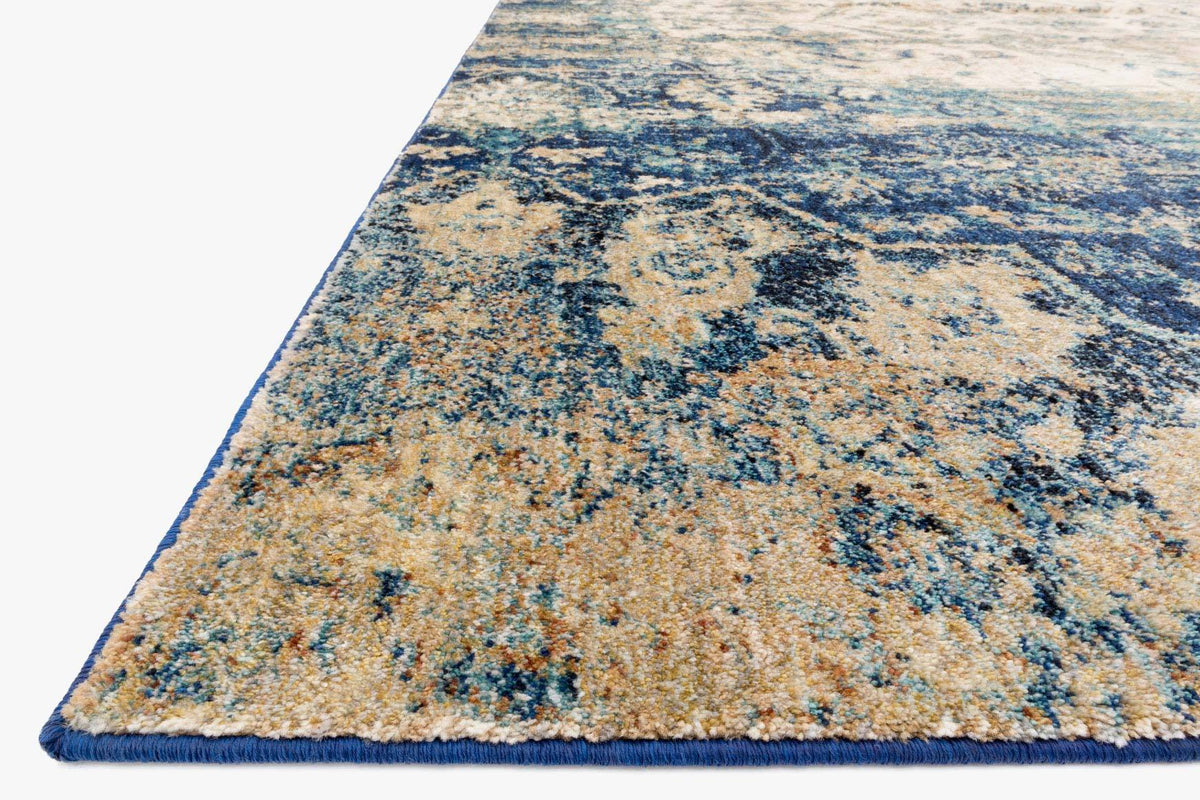 Blue and ivory power-loomed rug with distressed abstract pattern, corner view