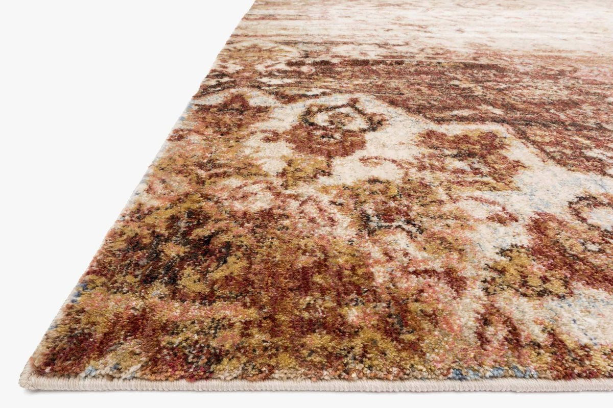 Rust and ivory rug corner detail with distressed ornate medallion pattern