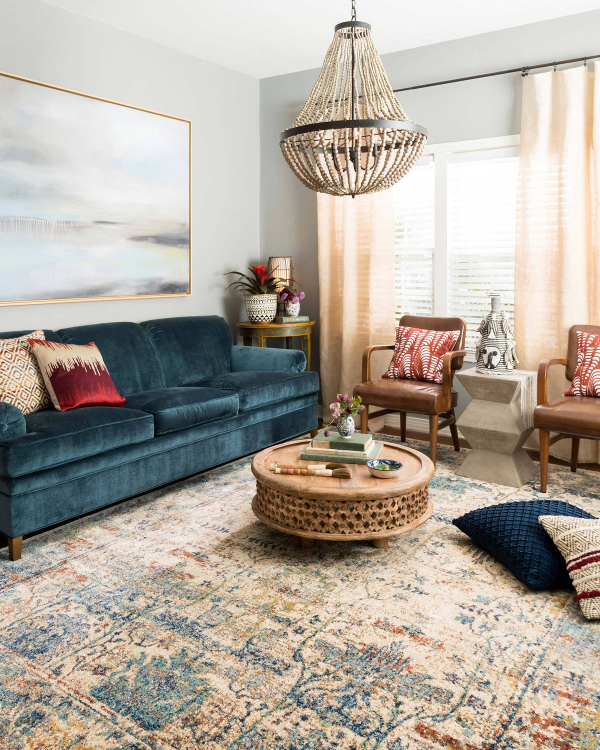 Transitional rug in sand and light blue with detailed vintage-inspired motif