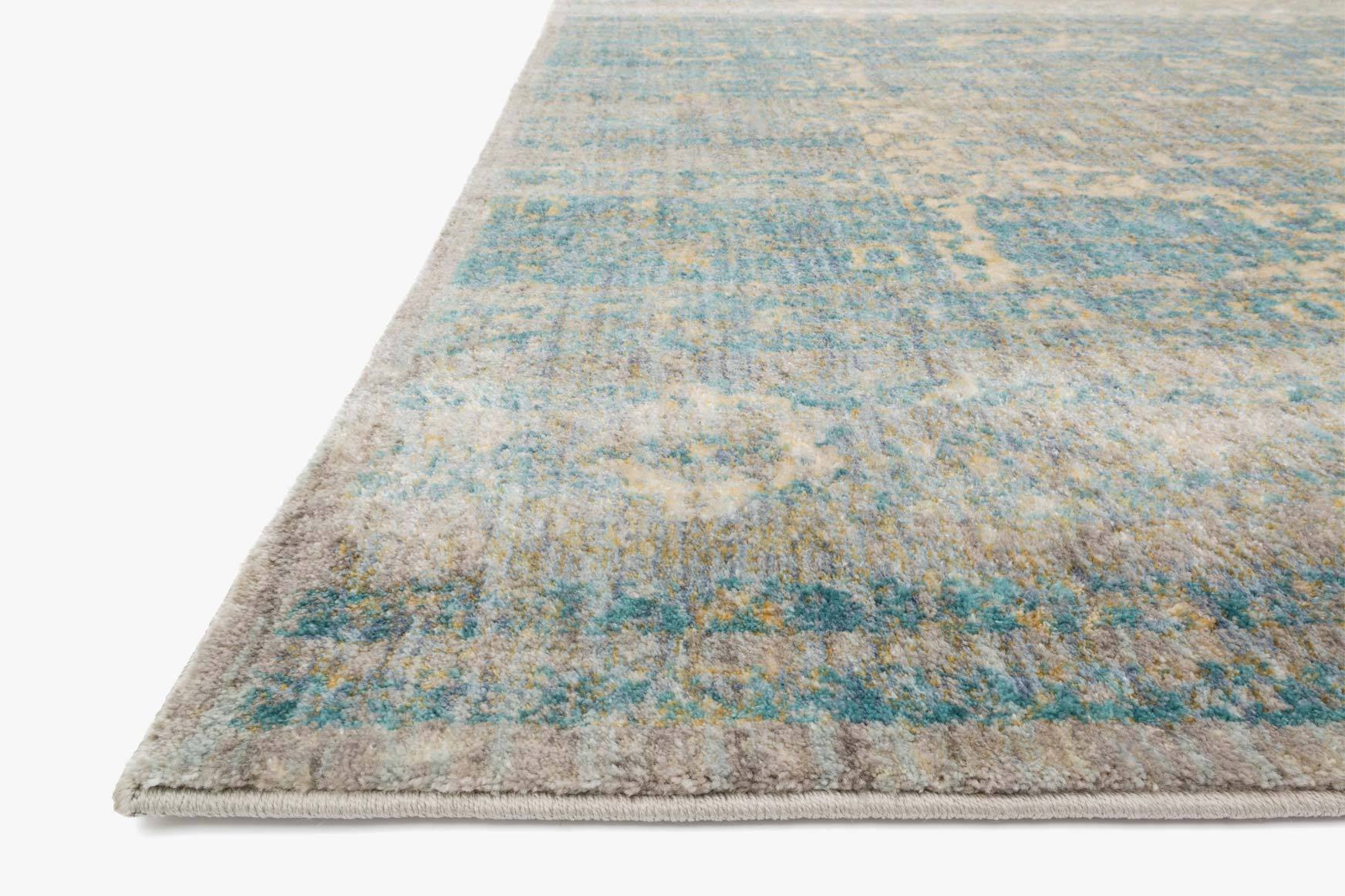 Corner view of light blue power-loomed rug with distressed texture and low pile