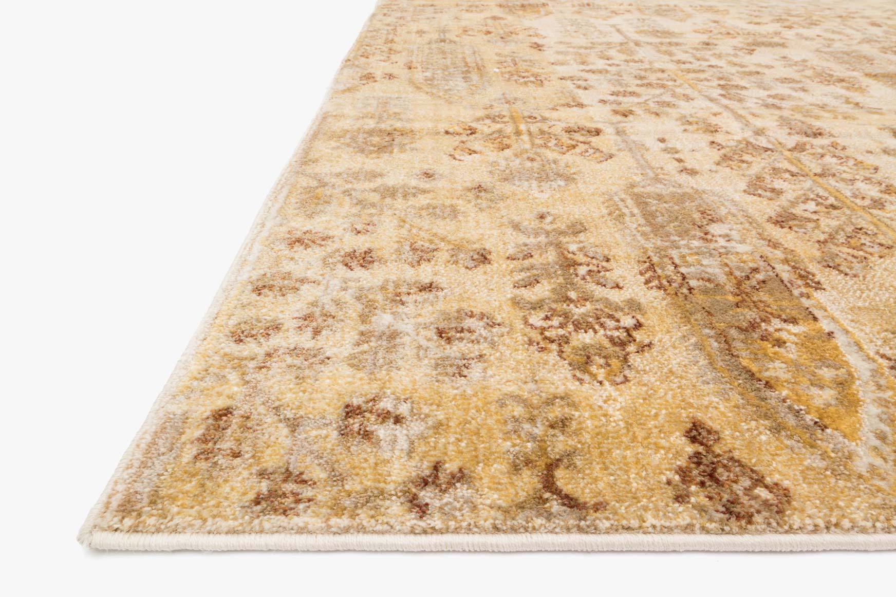 Detail of transitional rug in ivory and gold with distressed damask motifs.