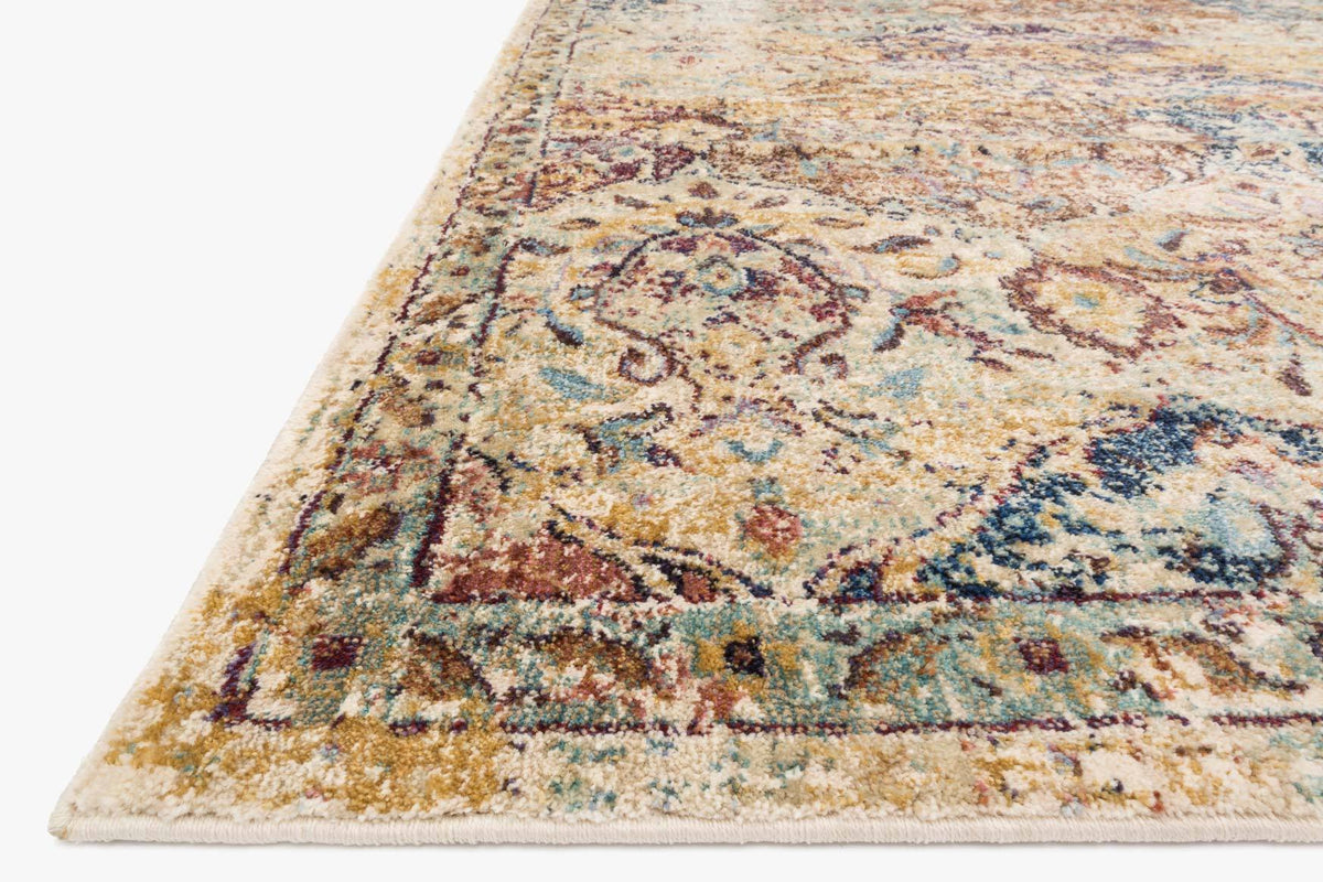 Ivory rug corner detail with dense multicolor motifs and flat woven border