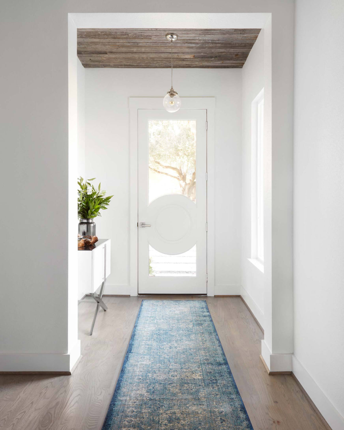 Light blue and ivory rug runner with distressed geometric medallion pattern