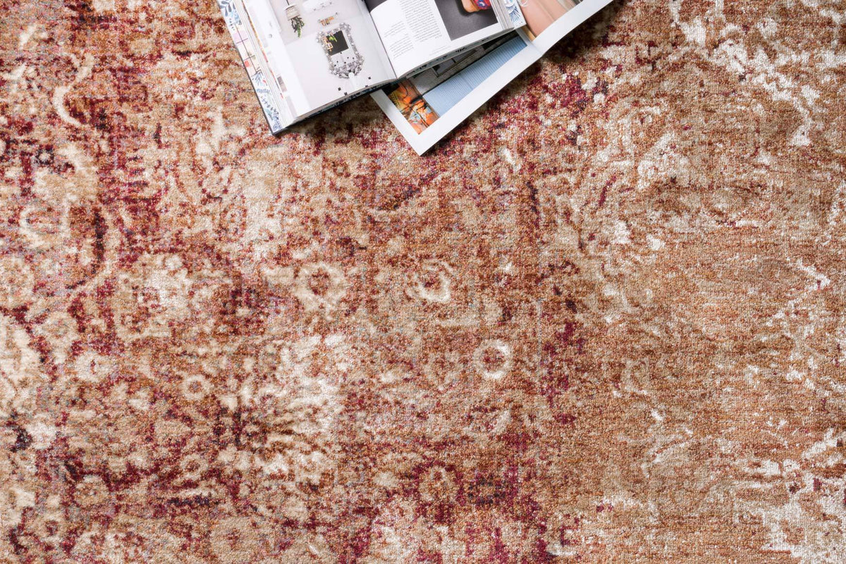 Copper and ivory abstract rug texture with distressed motifs, tight close-up detail.