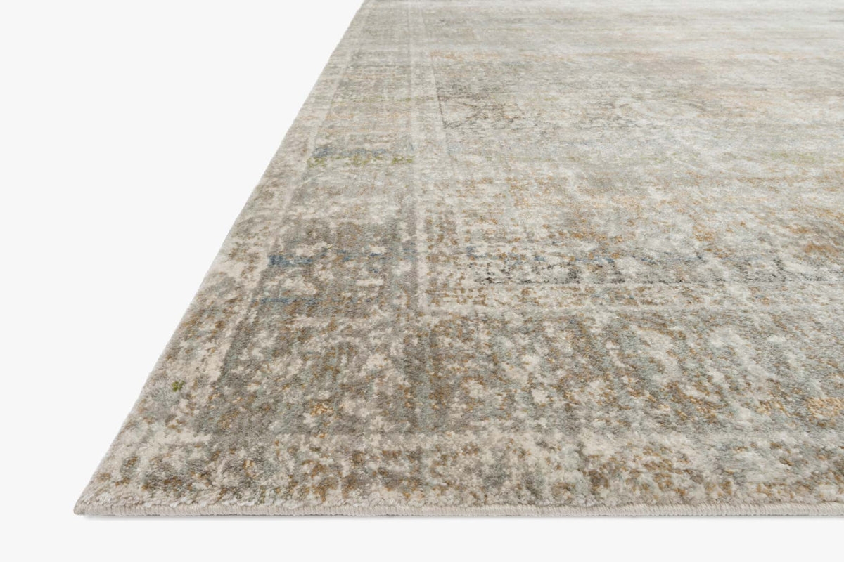 Corner view of grey power-loomed rug with faded distressed motif and subtle tan accents.