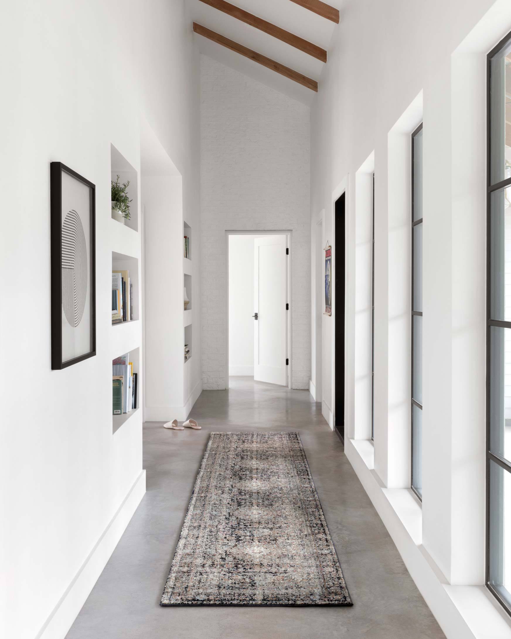 Charcoal-toned transitional rug in a hallway with abstract distressed pattern