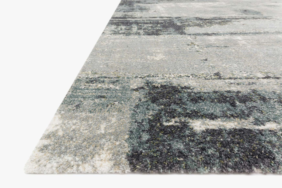 Slate blue abstract rug corner view with layered distressed squares