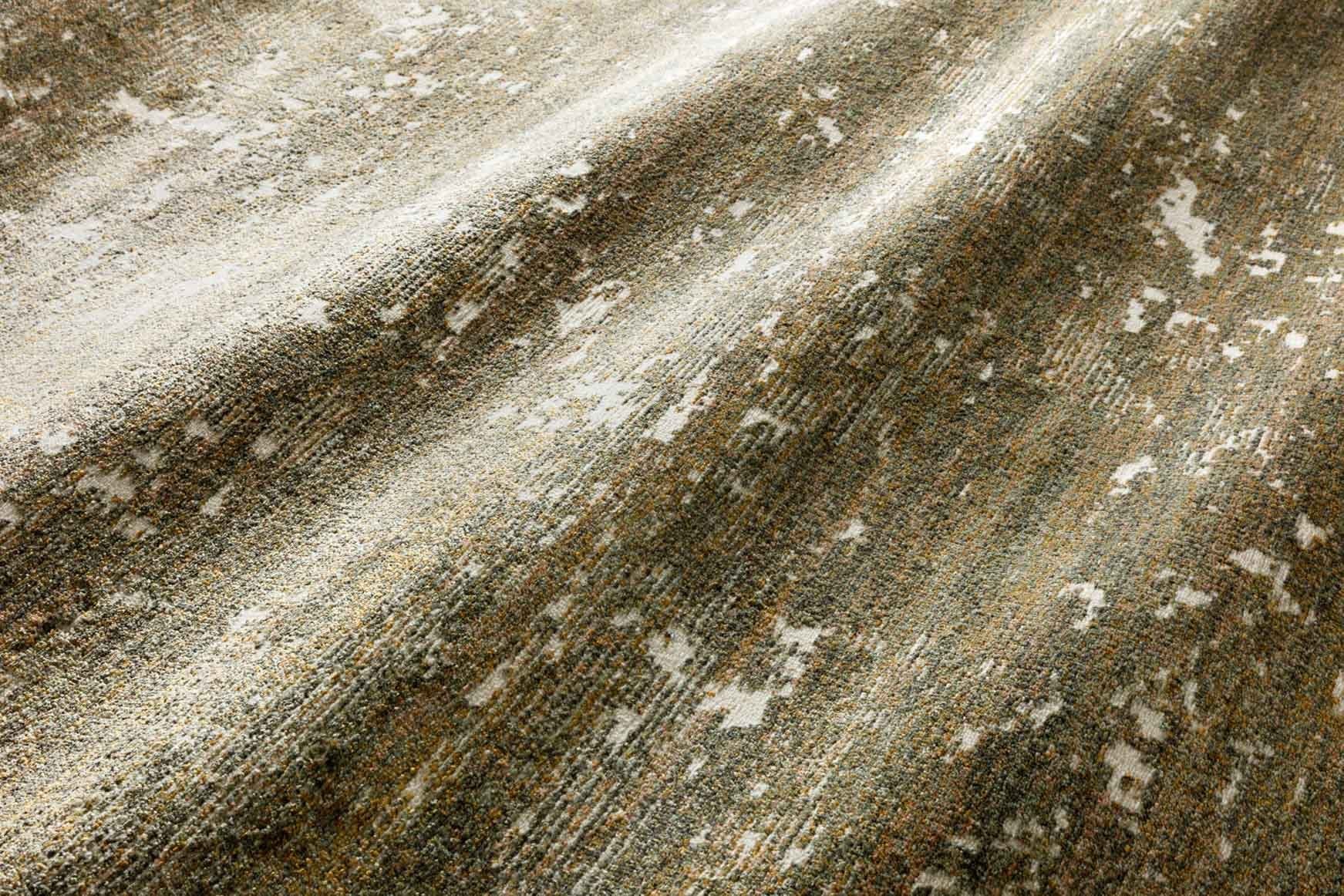 Contemporary power-loomed rug detail, moss green and spice tones with abstract speckle