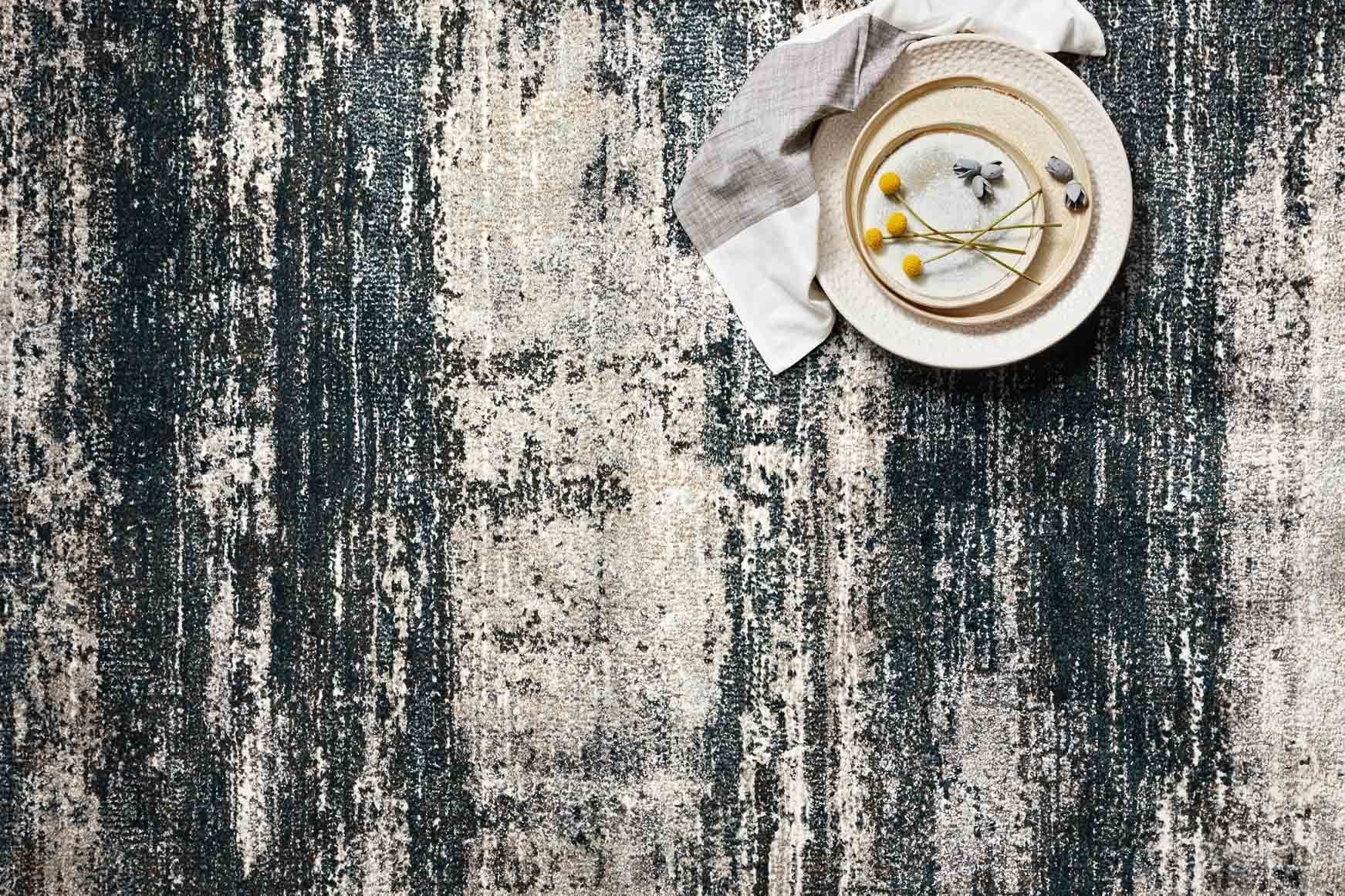 Navy and stone distressed abstract rug close-up with vertical speckled brushstrokes