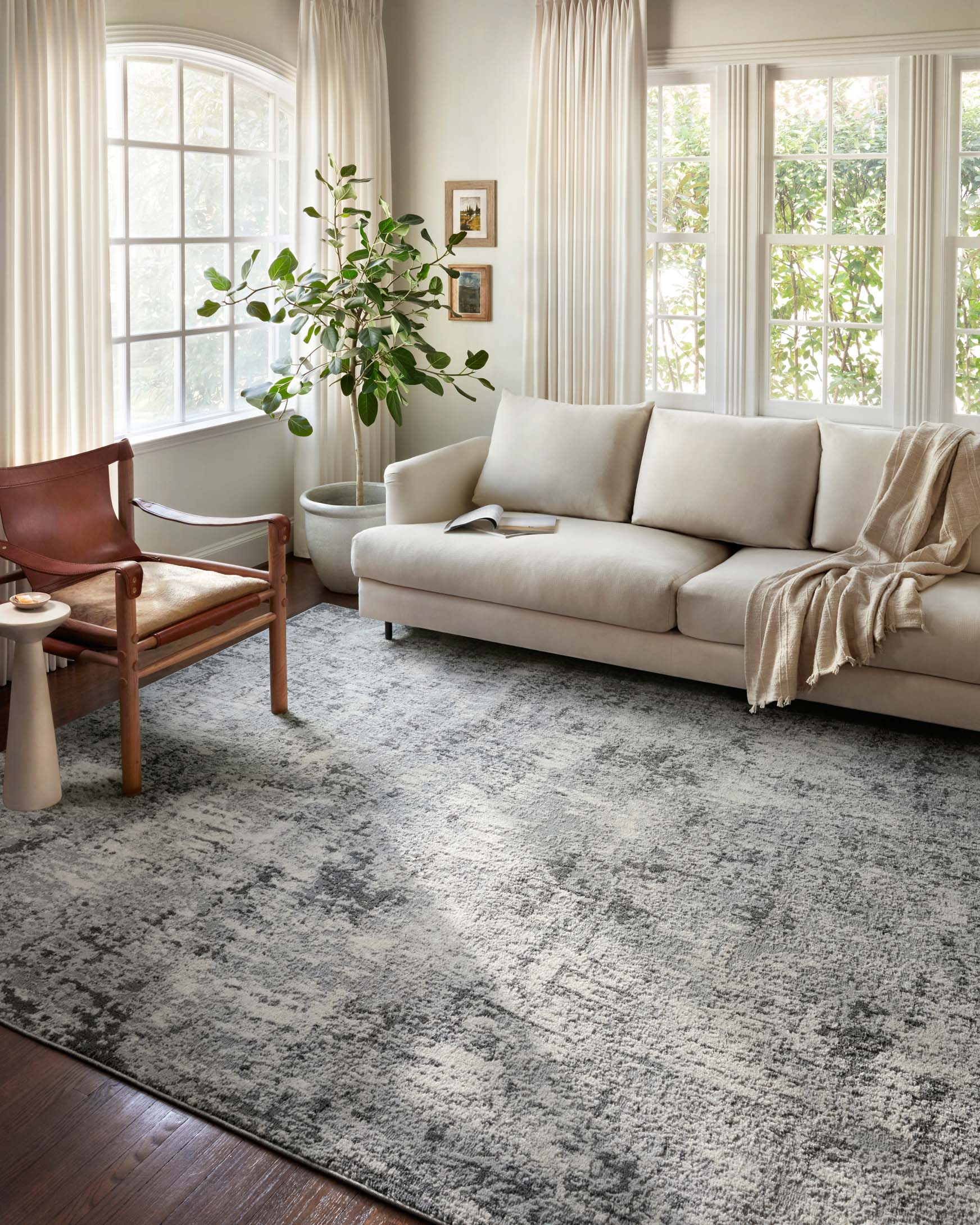 Pebble and charcoal abstract area rug with distressed texture and mottled design