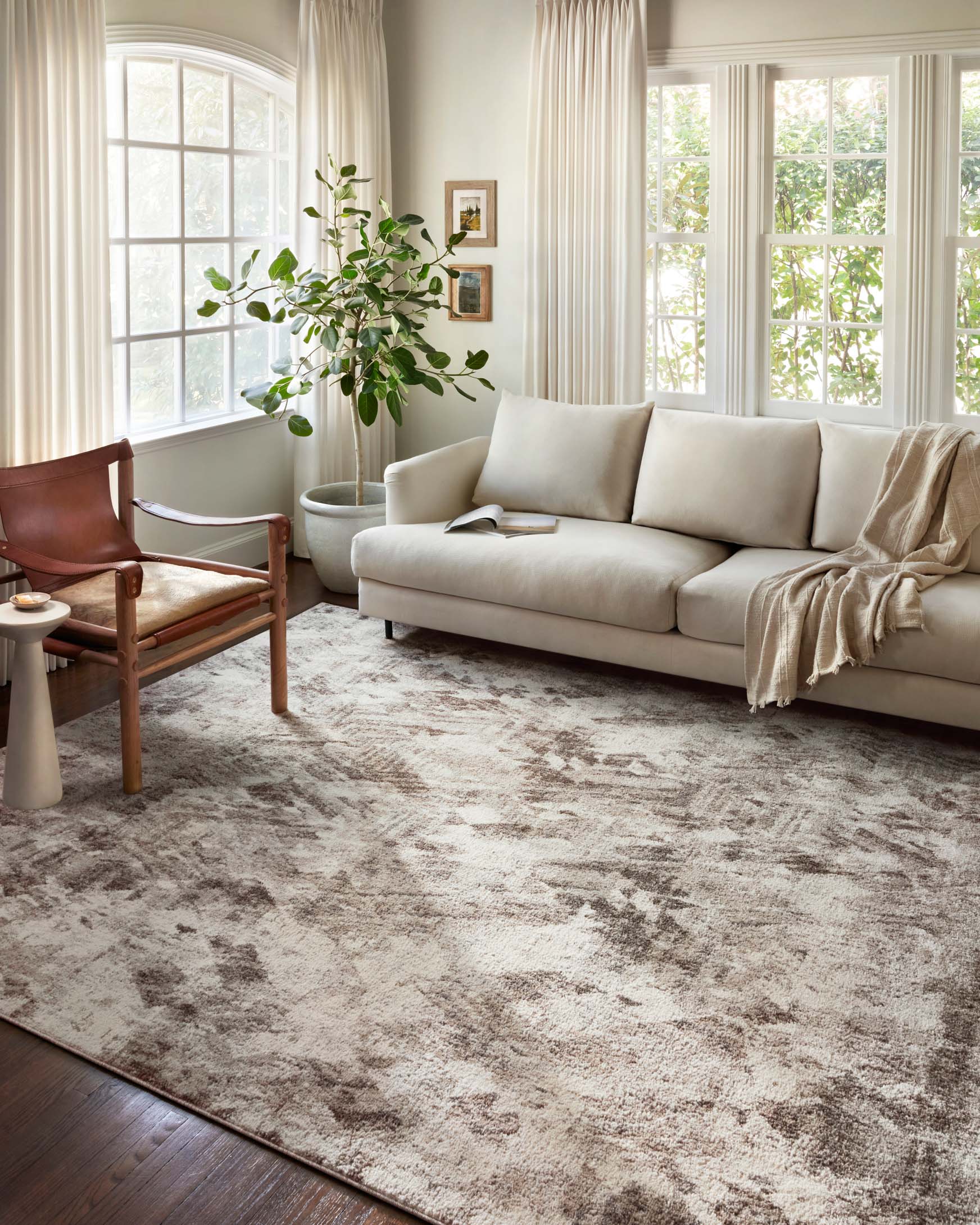 Large power loomed rug with abstract distressed pattern in natural and mocha