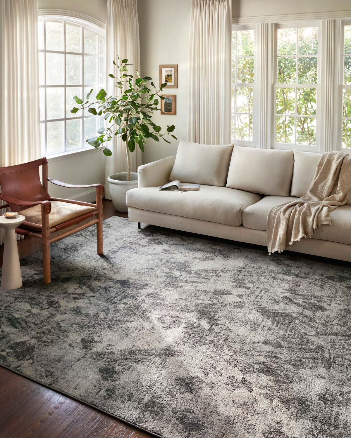 Abstract stone and pebble area rug in a living room, gray patterned surface