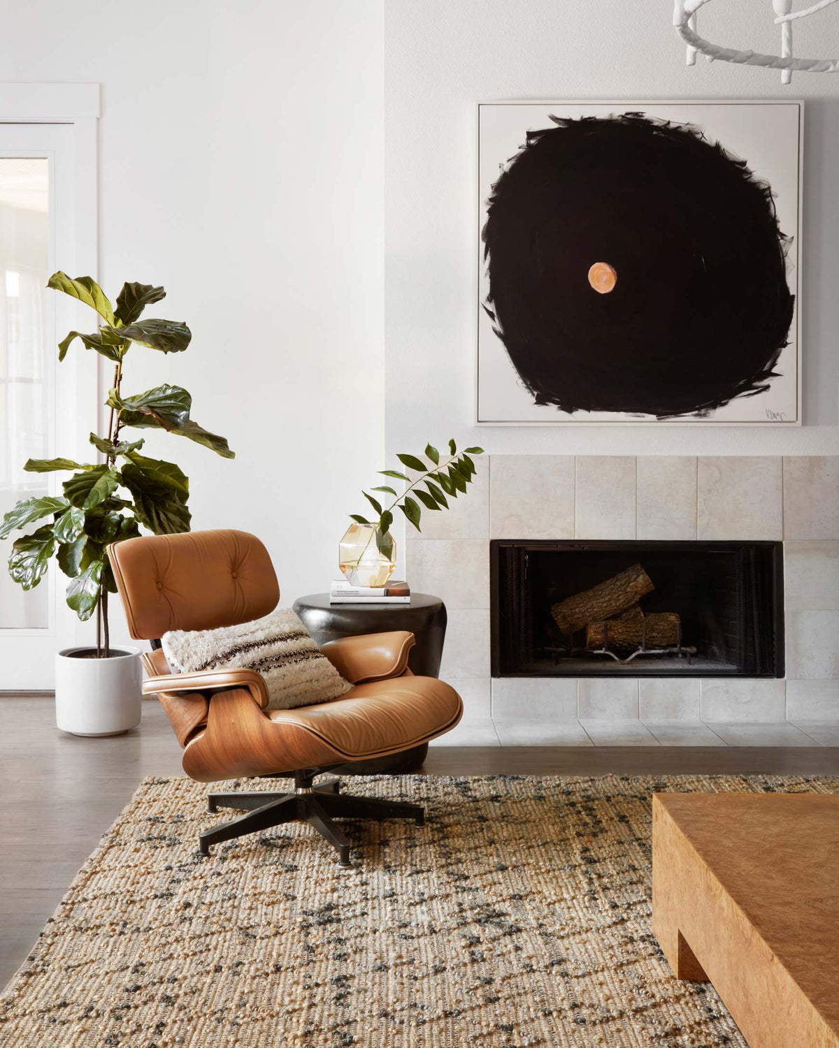 Contemporary hand-woven rug in beige with dark geometric pattern in foreground