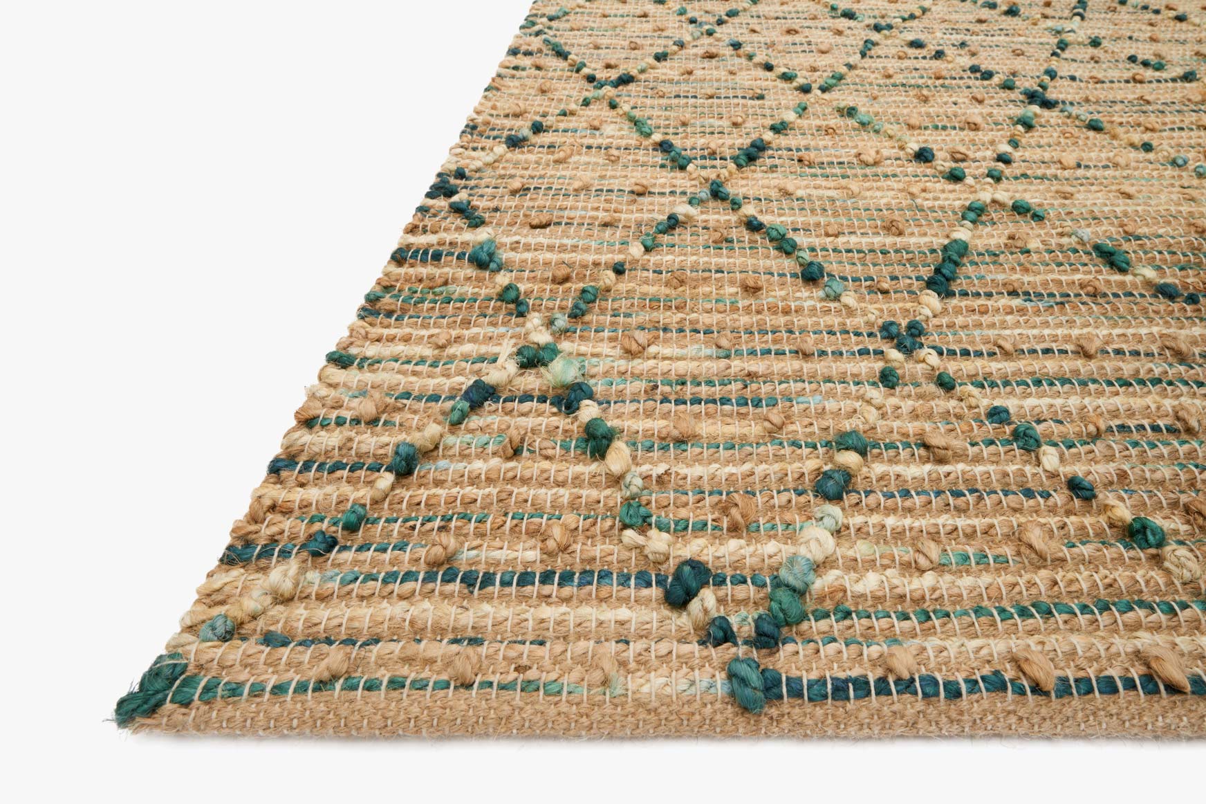 Hand-woven rug corner close-up showing braided texture with teal accents