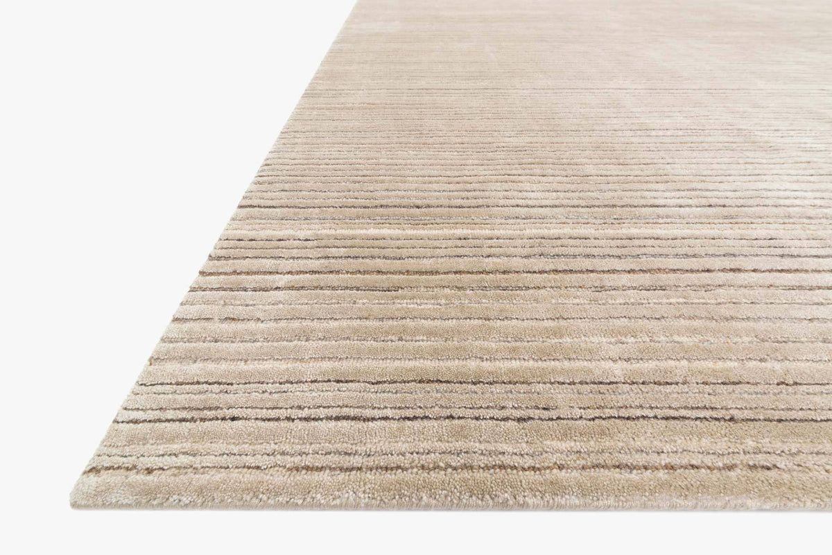 Oatmeal beige hand-loomed rug corner with horizontal stripe weave texture