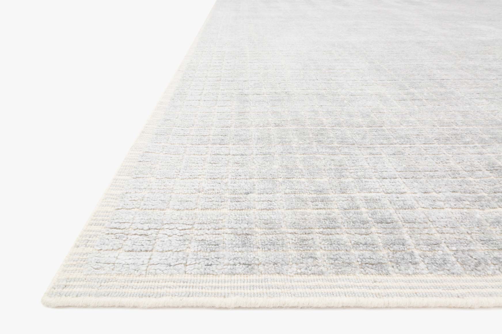 Contemporary hand-loomed rug, light silver-gray with pale sky-blue edge trim