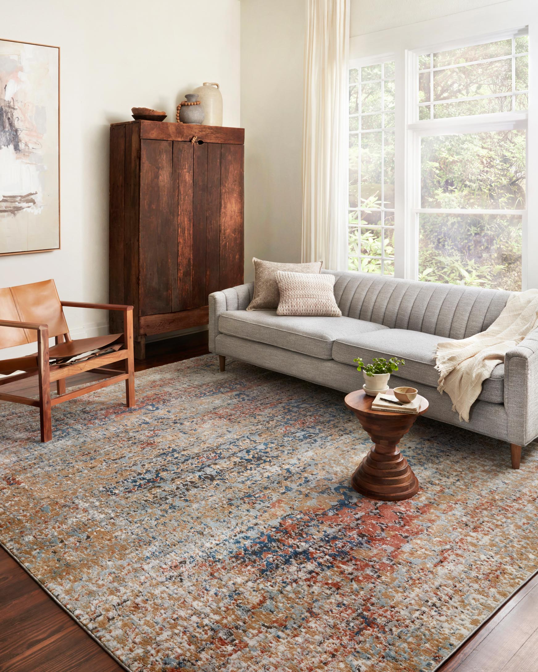 Large multicolor area rug with abstract speckled pattern in blue and spice tones