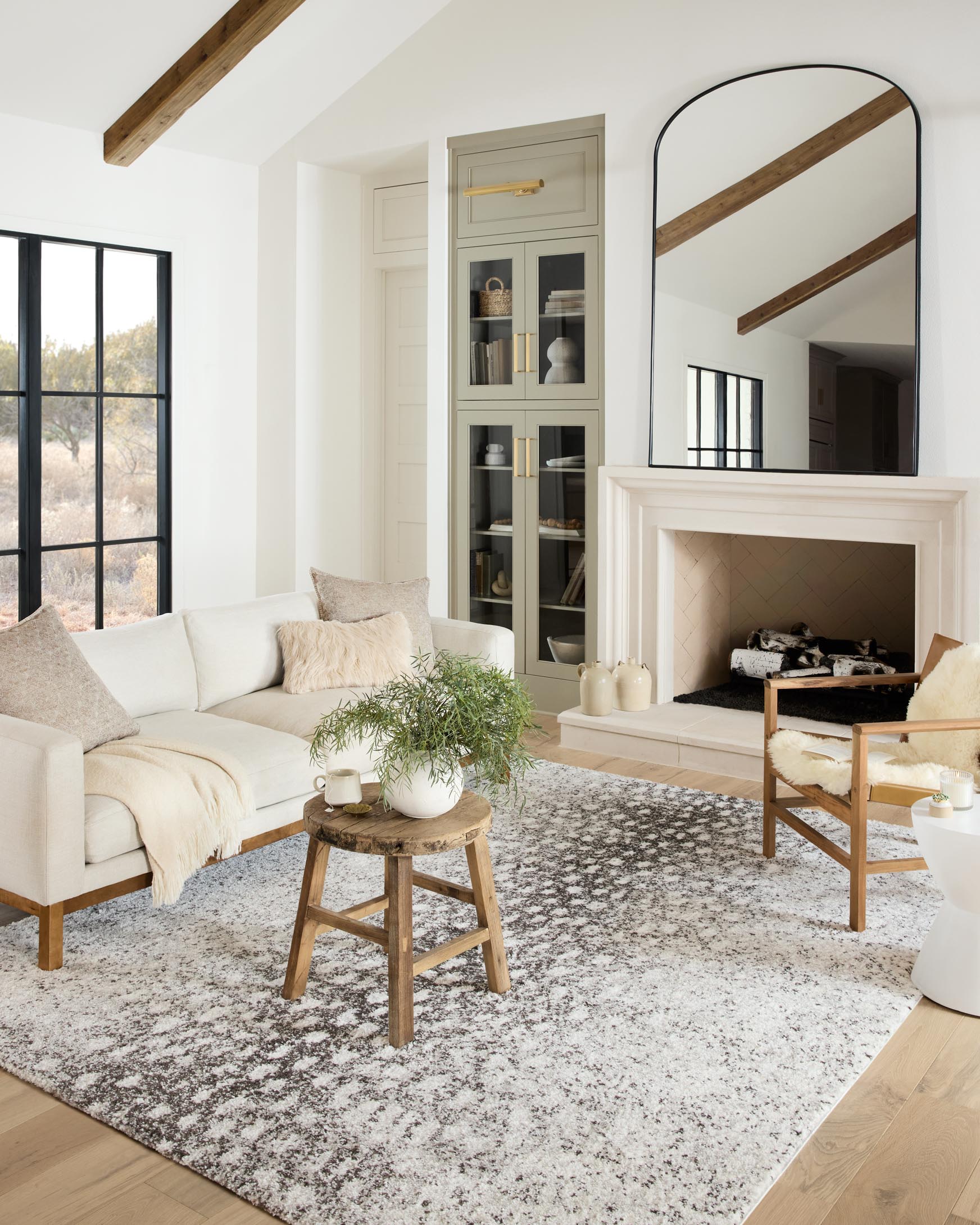 Grey and white shag area rug shown in a living room with seating