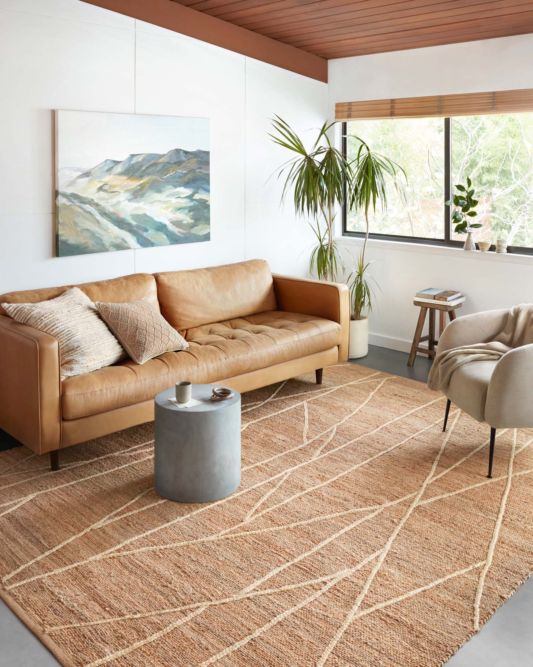 Tan contemporary rug with ivory linear pattern, laid flat on the floor