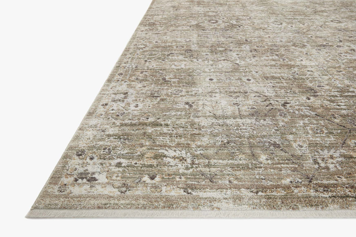 Traditional power-loomed rug corner view, distressed texture in moss and bark