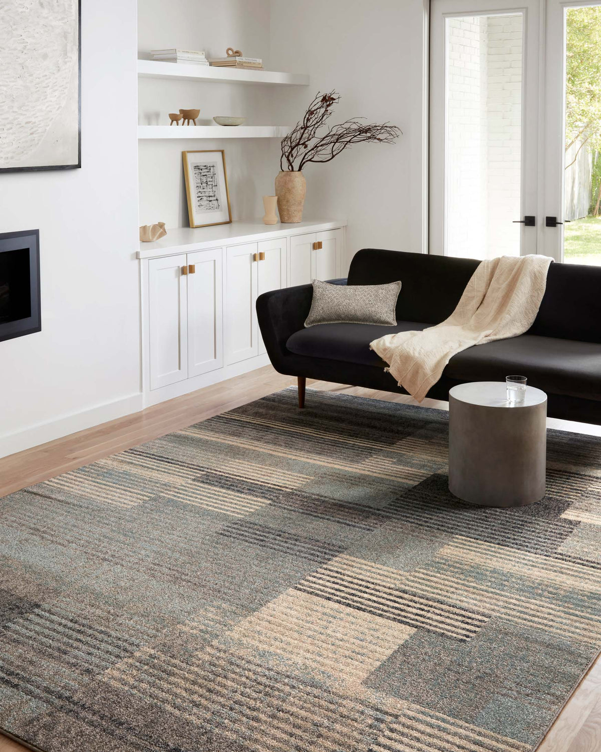 Abstract storm-and-taupe area rug with rectangular stripe pattern in a living room