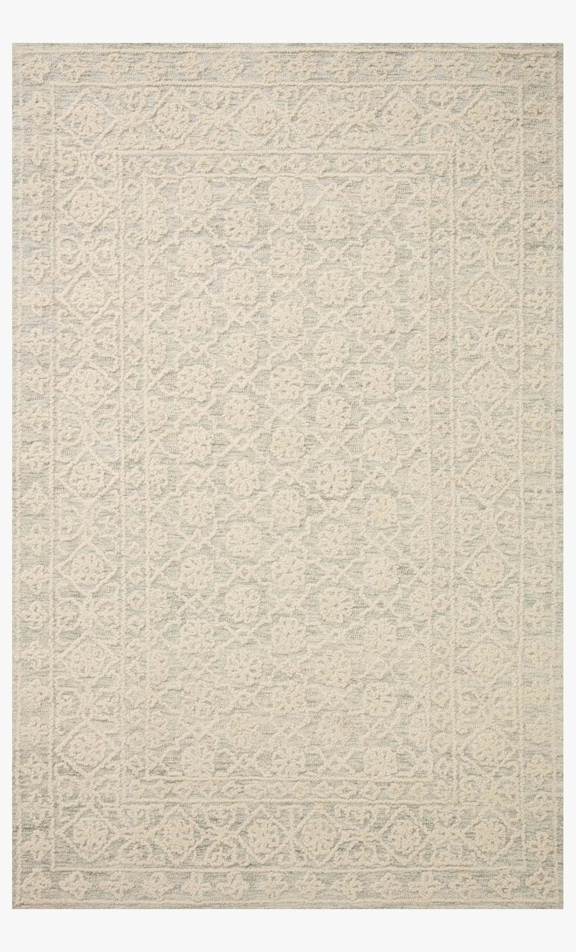 Hand tufted area rug in mist and ivory with subtle geometric pattern and rectangular border