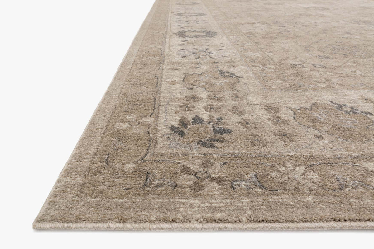 Taupe power-loomed rug corner with low-pile texture and scattered geometric motifs