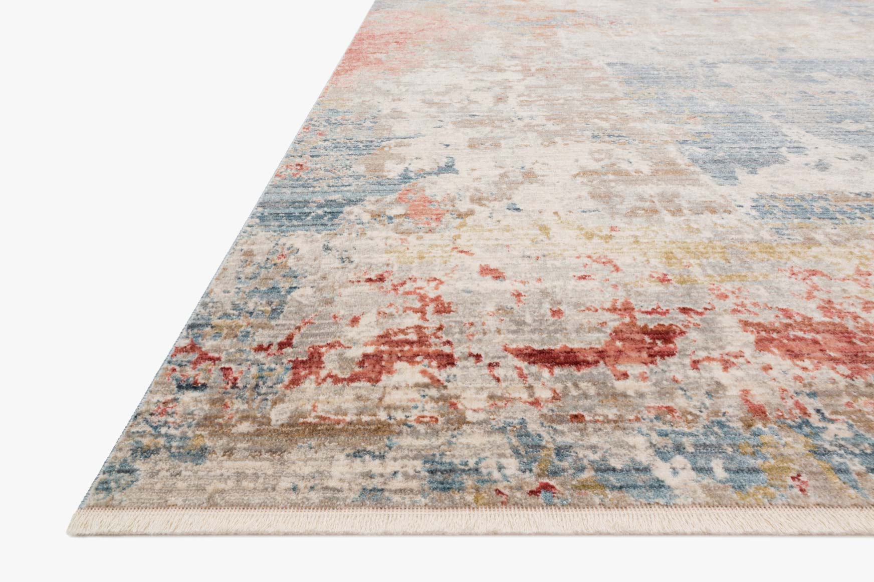 Corner view of traditional power-loomed rug with distressed abstract pattern in grey tones