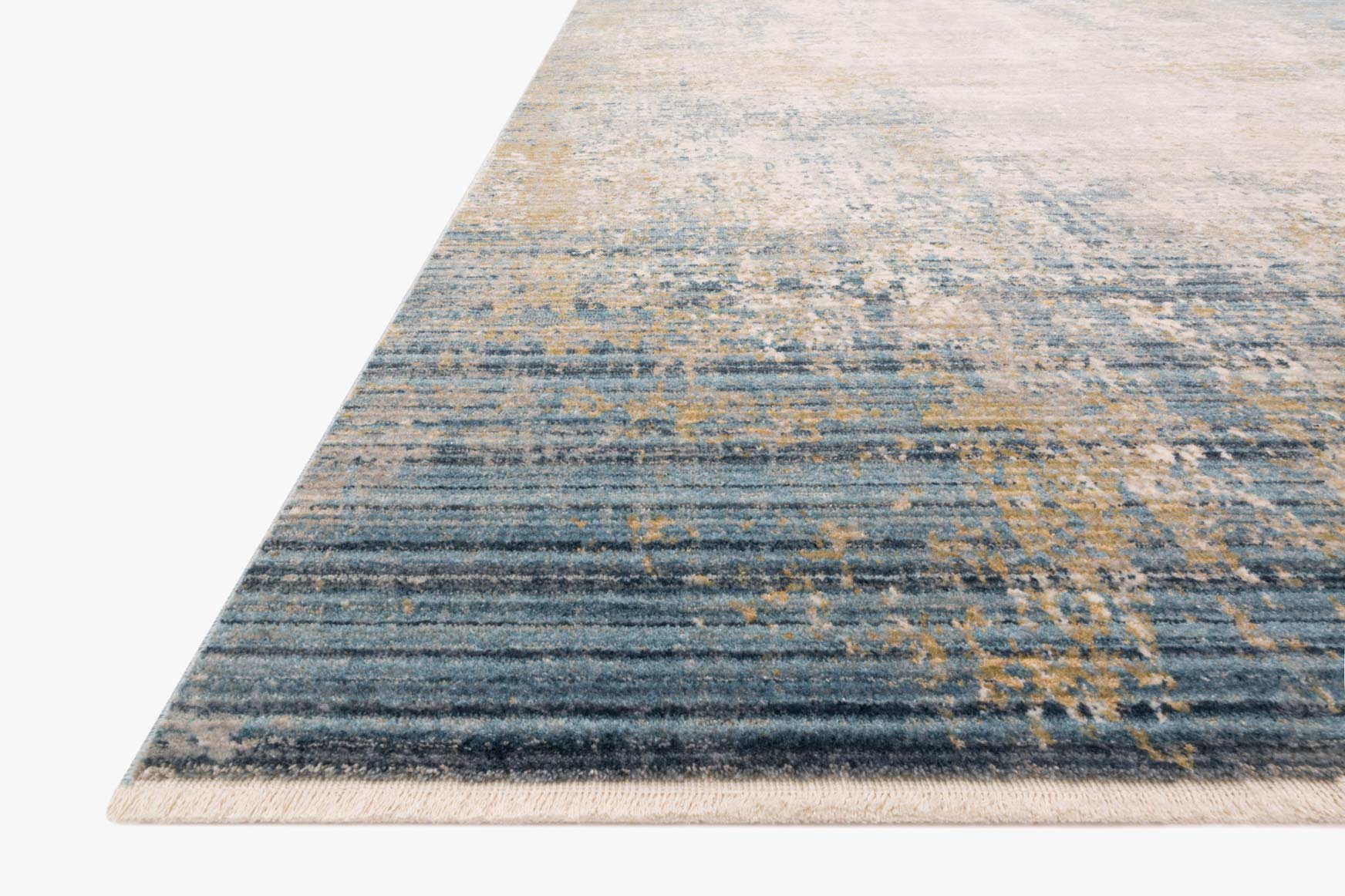 Corner view of neutral and sea blue rug with distressed textured pattern