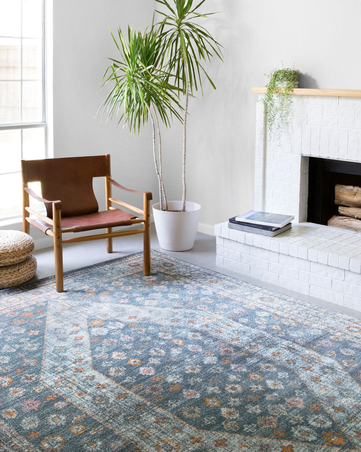 Blue and light blue power-loomed area rug with distressed floral-geometric pattern