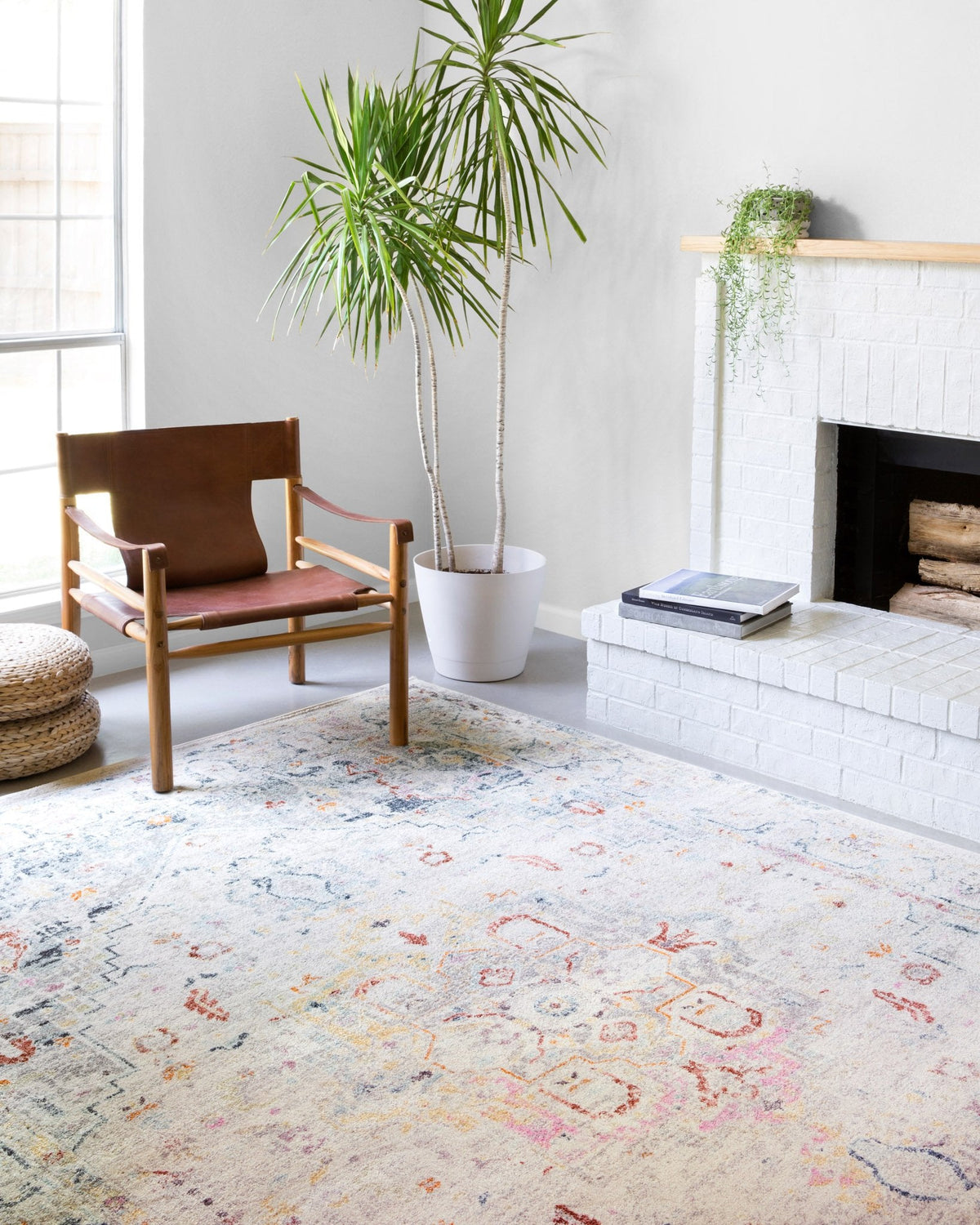 Light grey transitional rug with distressed medallion pattern and orange-blue accents