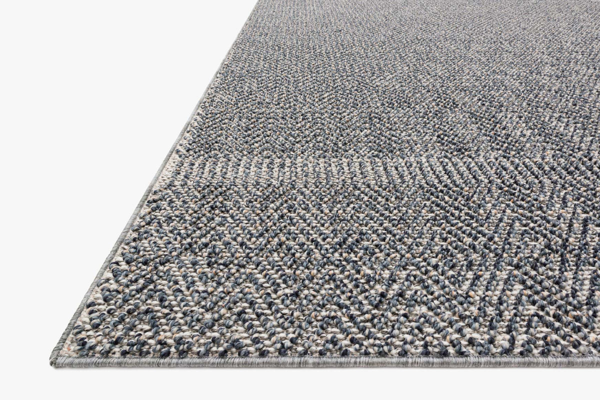 Indoor/outdoor rug corner detail, blue-and-grey textured power-loomed weave