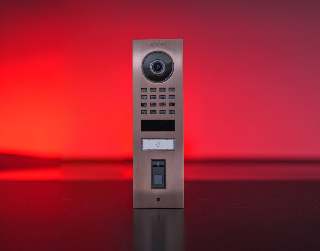 Bronze IP video door station front with camera lens, keypad, and integrated call button