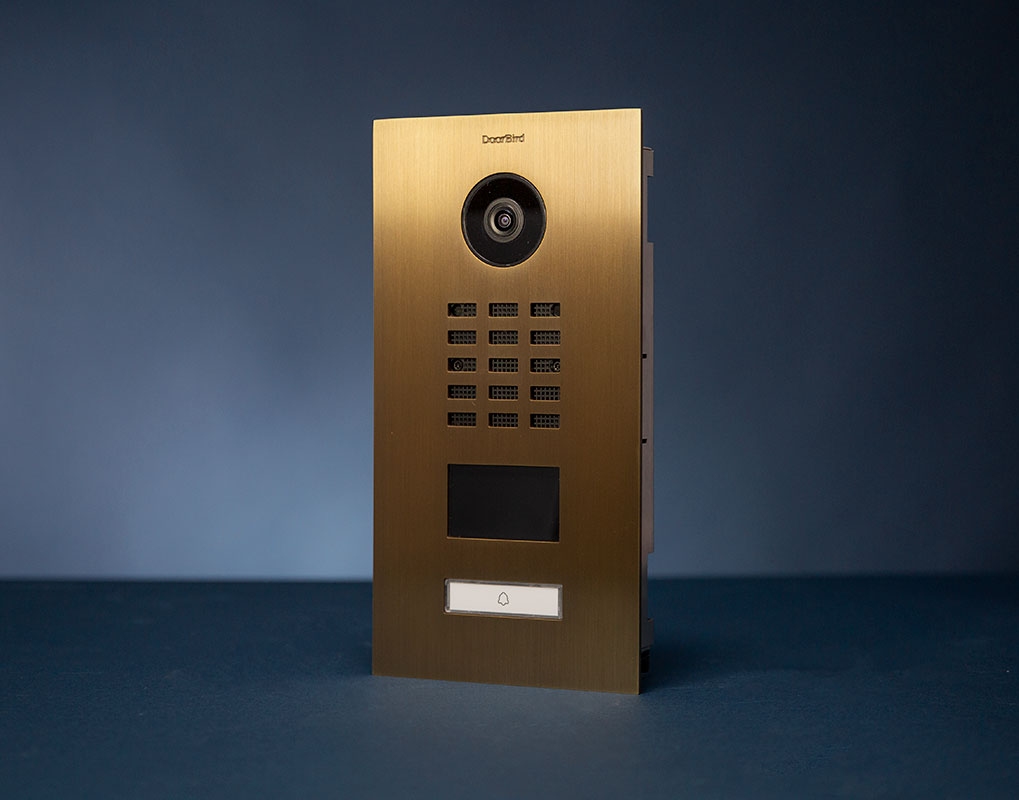 Burnished brass door video station panel with camera, keypad, and nameplate