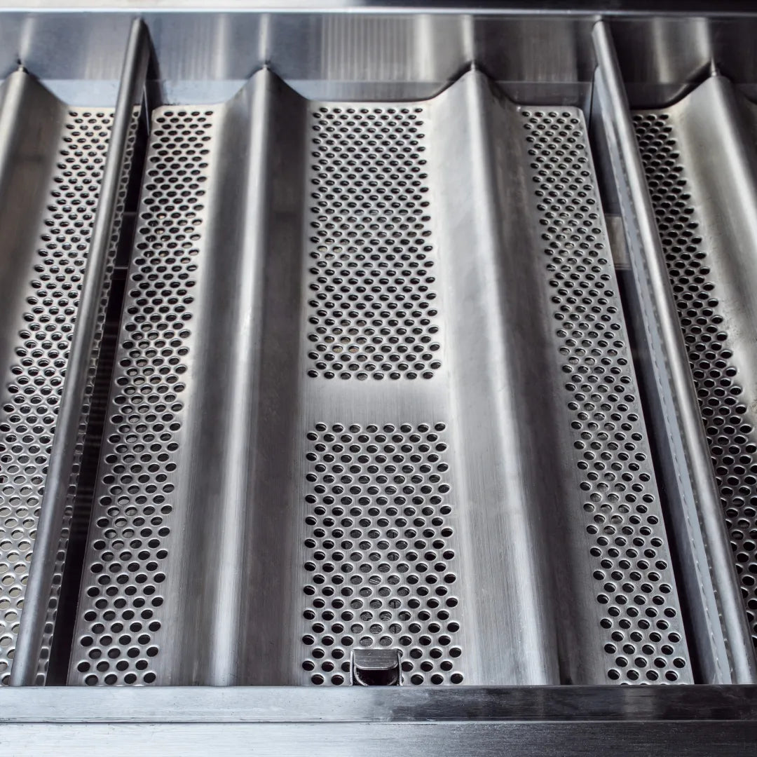 Stainless steel heat shields with perforated vents above the grill burner area