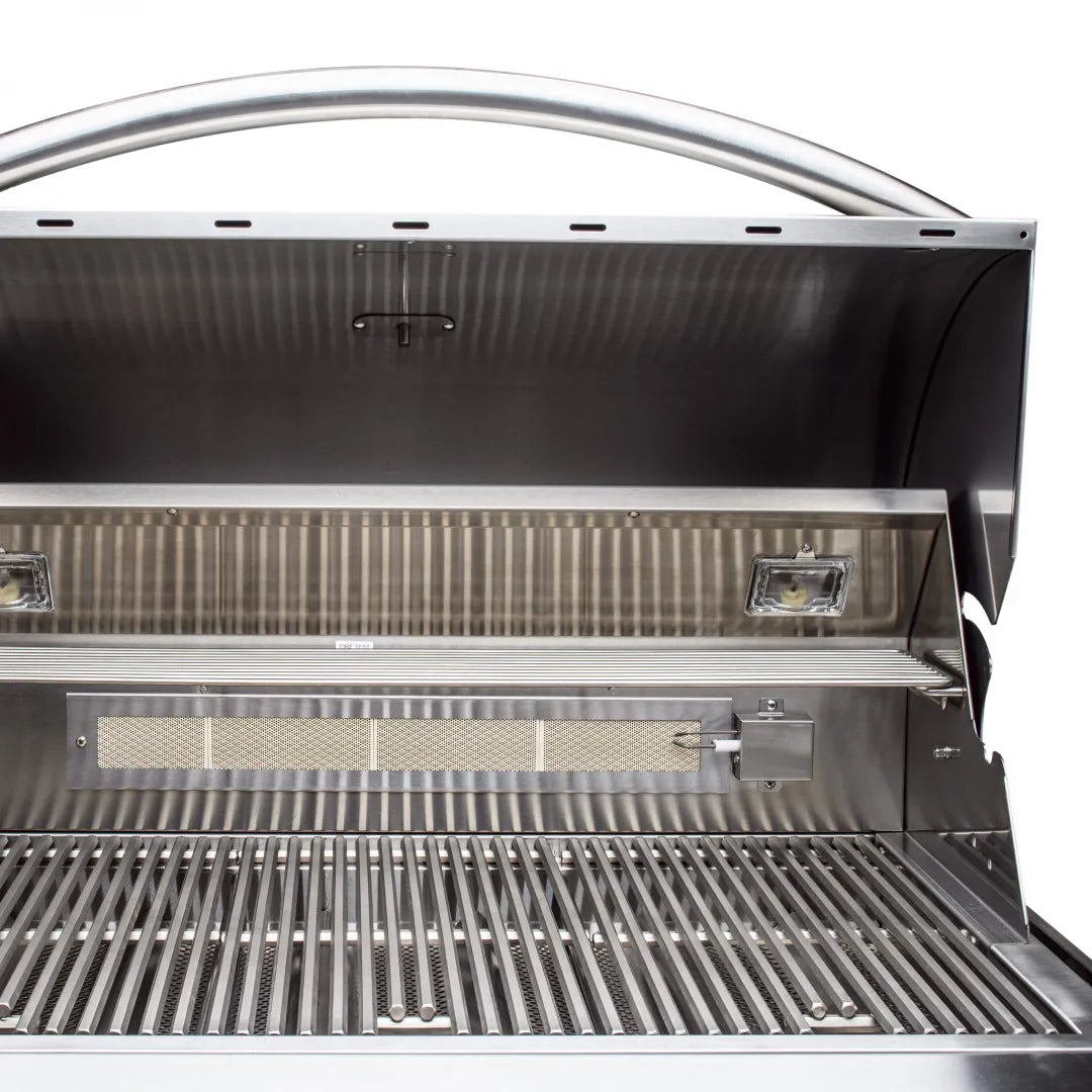 Built-in natural gas grill open lid showing rear burner area and cooking grates
