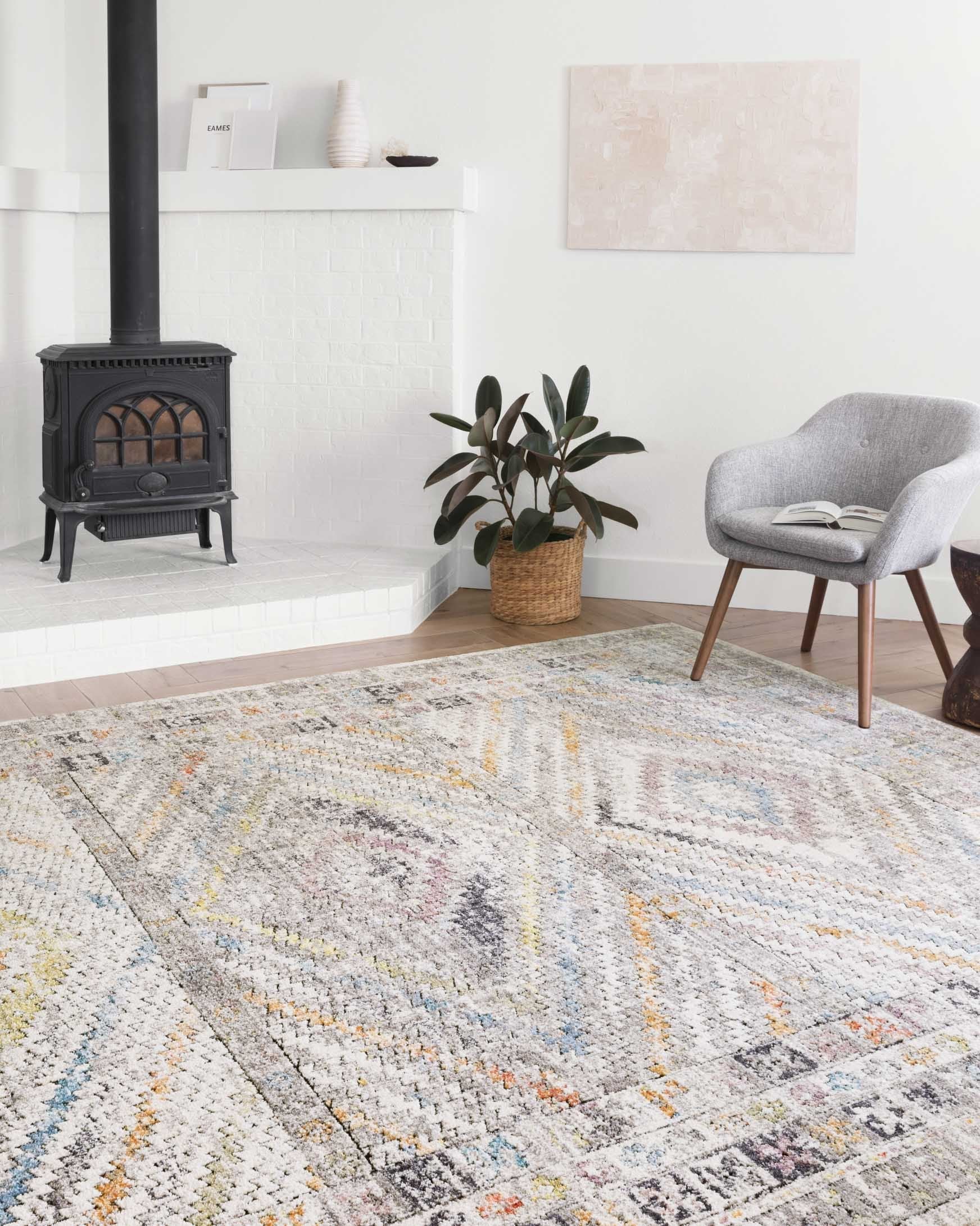 Ivory geometric rug with multicolor pattern in a bright living room setting