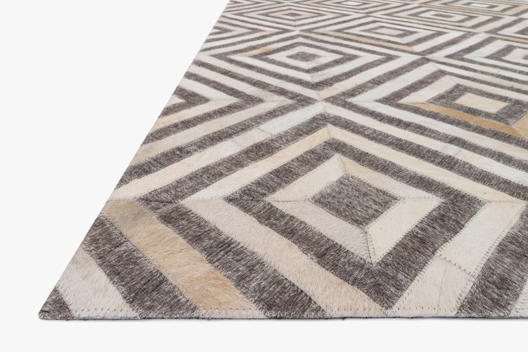 Contemporary hand-stitched rug, angled view, taupe and sand chevron with diamond accents
