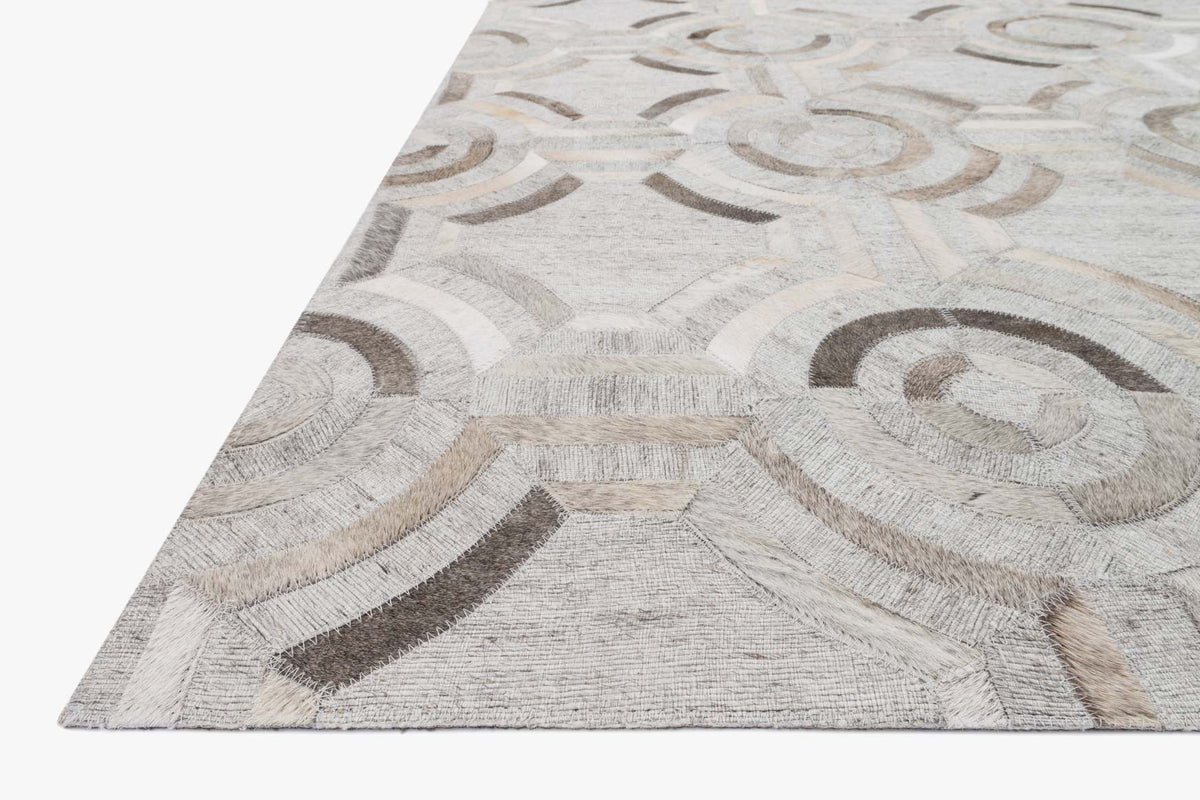 Contemporary hand-stitched rug corner with layered grey geometric pattern