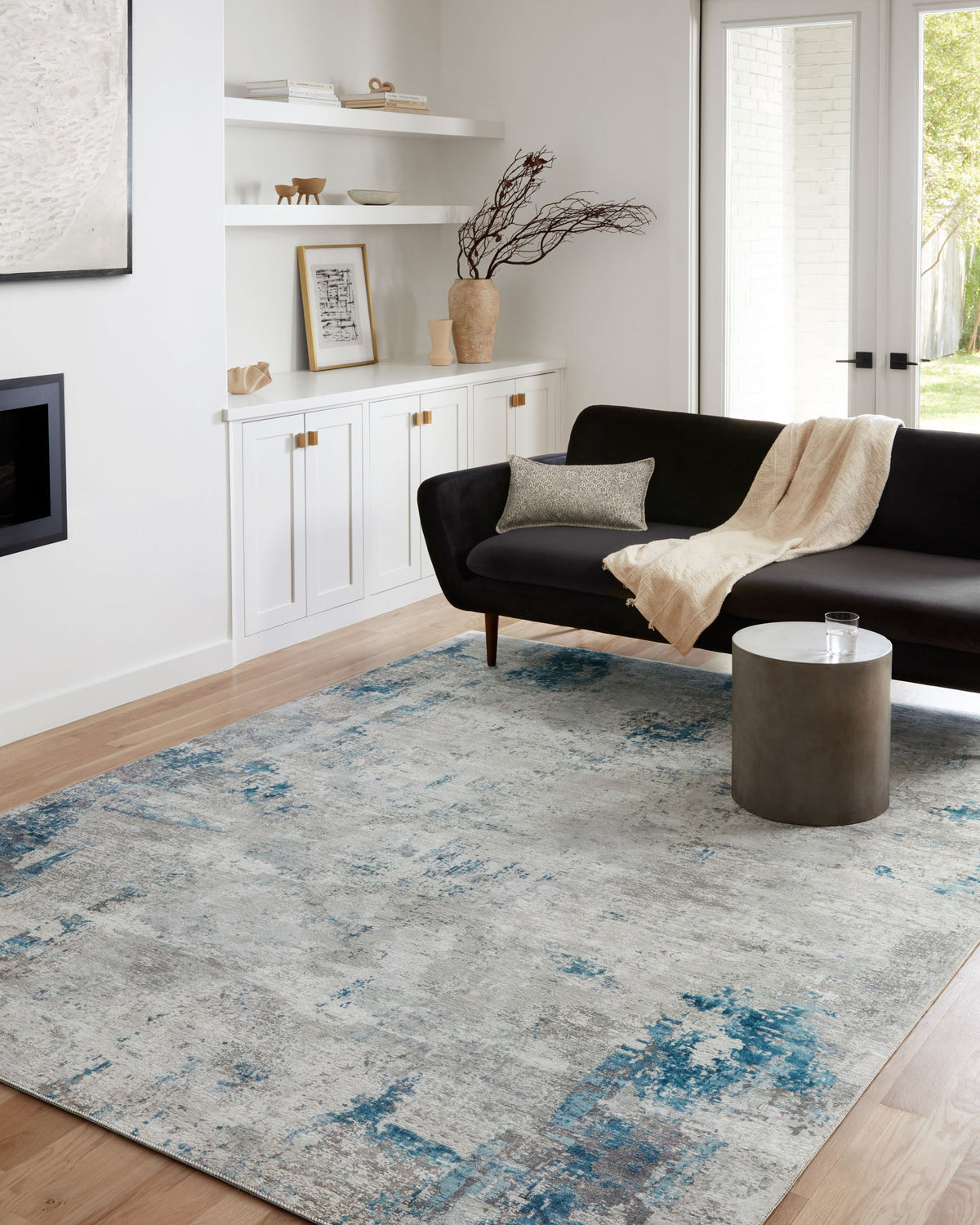 Contemporary abstract rug in light gray with scattered blue distressing